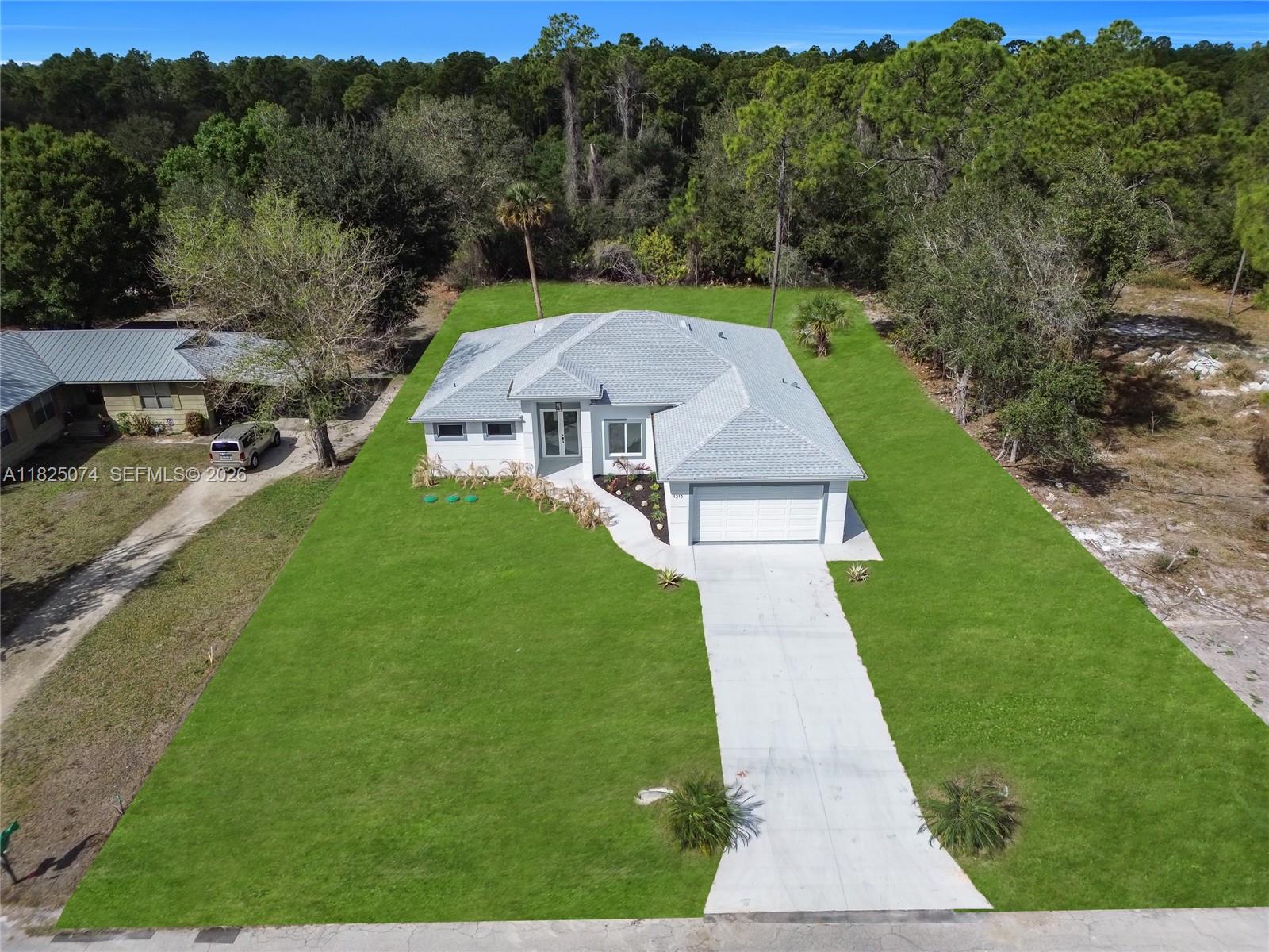 1215 Fitch Ave, Lehigh Acres FL 33972 — #A11825074